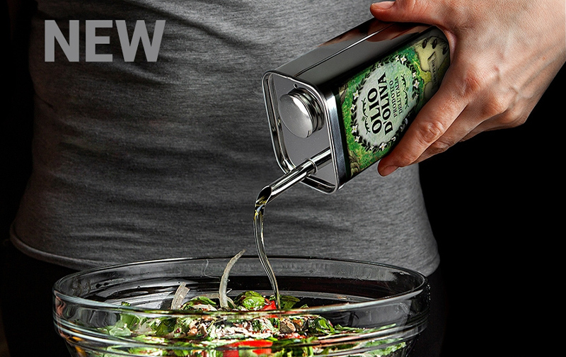 Hand pouring extra virgin olive oil from tin onto mixed sala